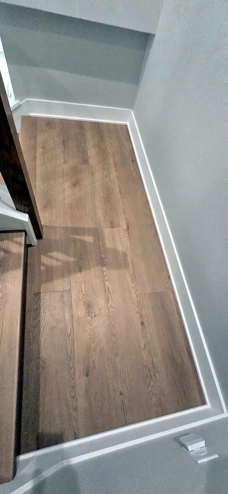 Oak-look plank flooring and white baseboard along a landing, the kind of durable, easy-to-clean floor many Apopka homeowners look for