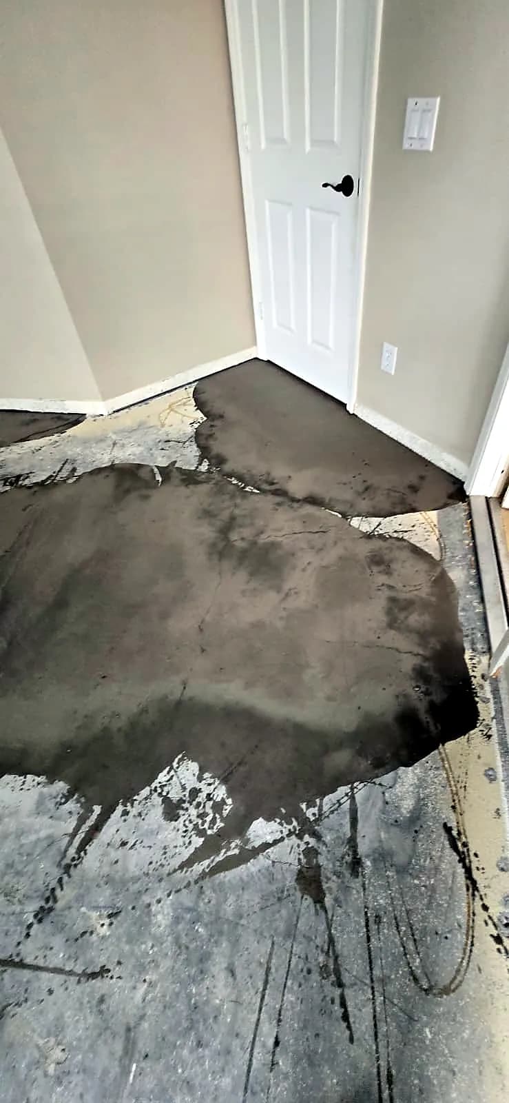 Self-leveling compound poured on a concrete slab before new flooring